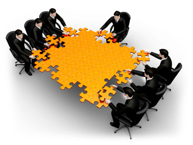 Businessmen Putting a Table Jigsaw Together