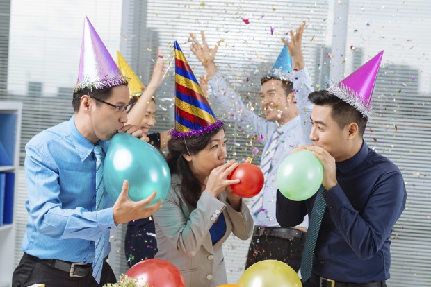 Business People Celebrating and Blowing up Balloons