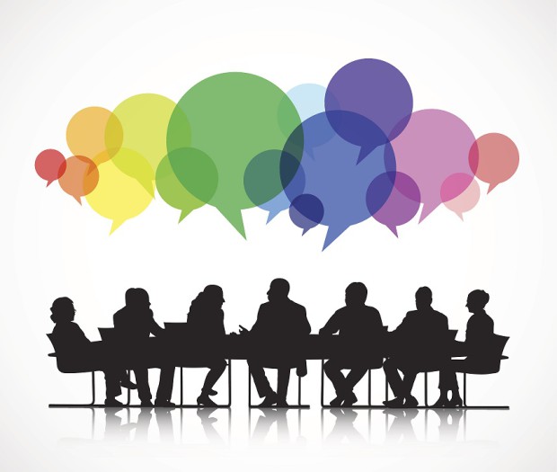 Silhouettes of People in a Meeting with Colourful Speech Bubbles Above Their Heads