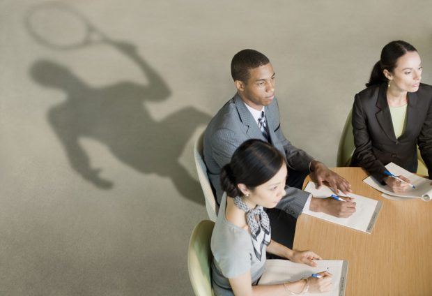 Business man in a Meeting With his Shadow Holding A Tennis Racket