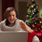 happy young woman having christmas video chat with family
