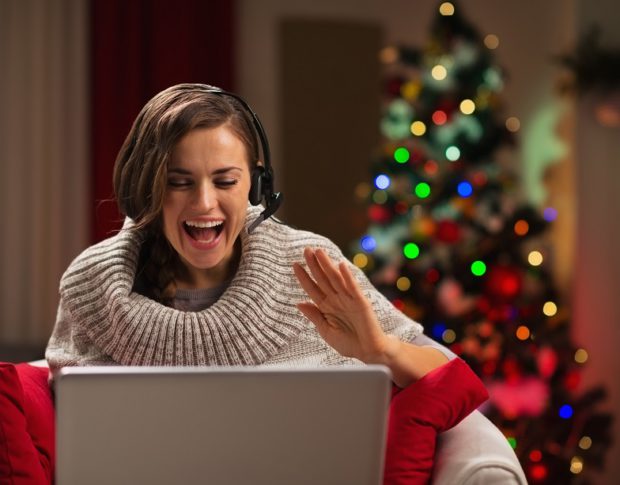 happy young woman having christmas video chat with family