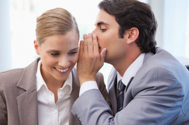 Man Whispering in Meeting Participants Ear