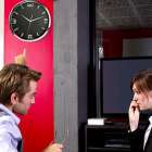 Female office worker being taken to task over bad time keeping
