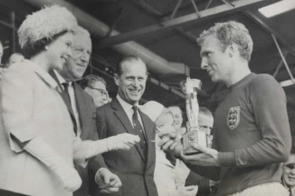 Queen Elizabeth II presenting the football world cup trophy to Bobby Moore
